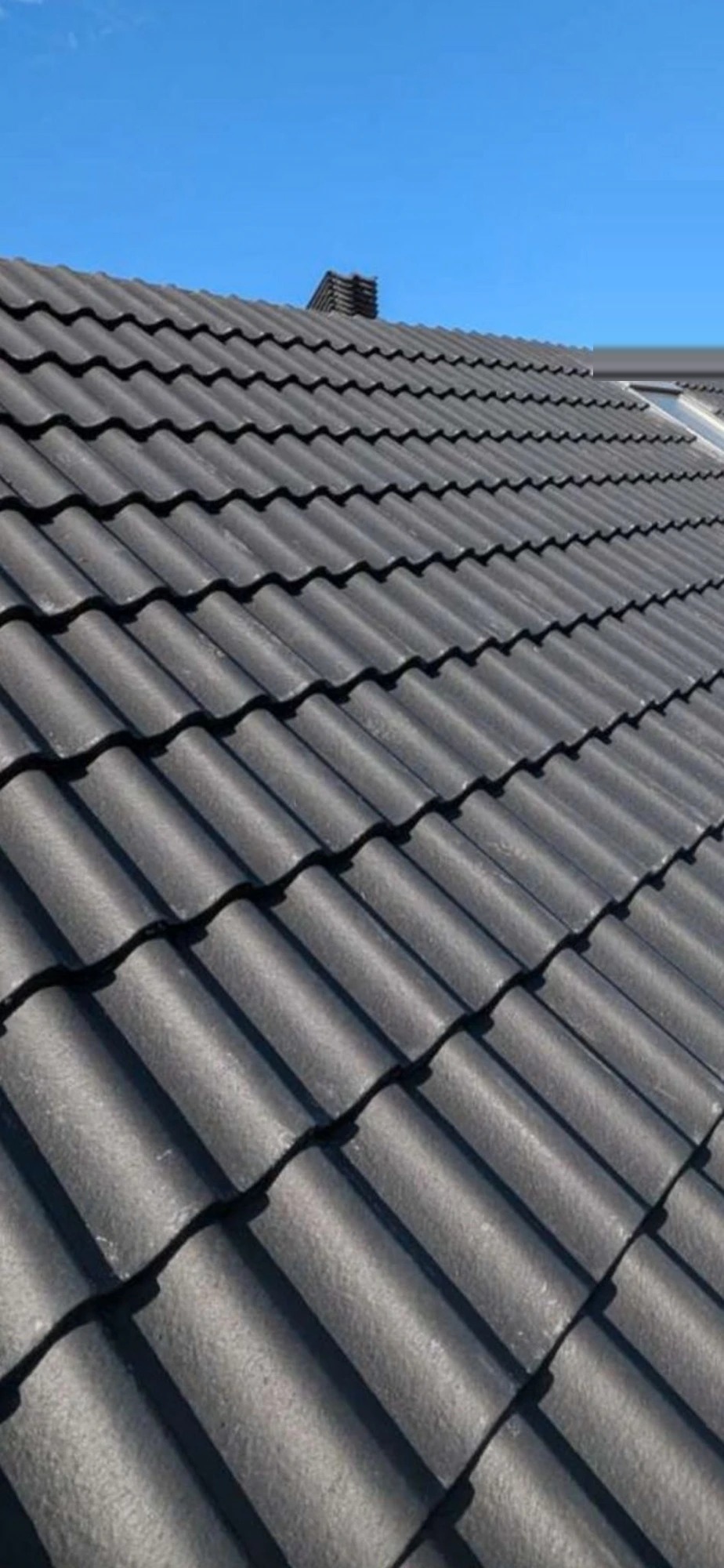 Rocksteady Roofing roof replacement in progress — new battens, breathable membrane and tiles loaded