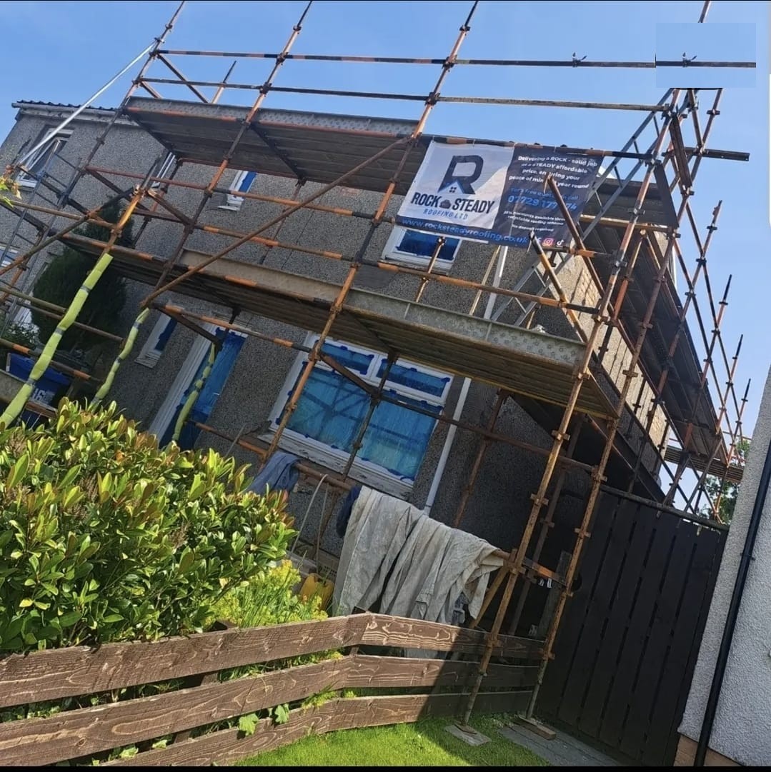 Before — home mid-roughcasting with scaffolding